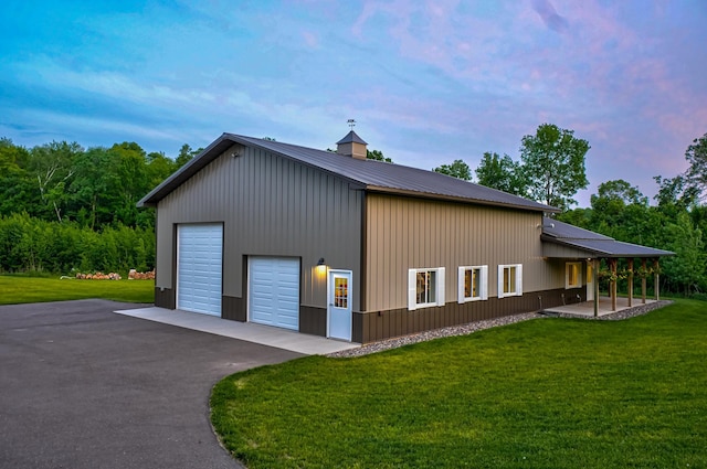 1994 80th St, Somerset, WI 54025 - view of side of home featuring a garage, a lawn, and metal roof