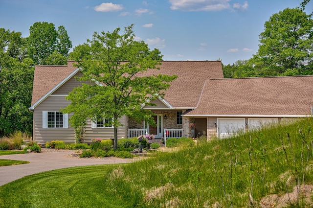 1994 80th St, Somerset, WI 54025 - view of front facade with a porch, a shingled roof, a front lawn, and an attached garage