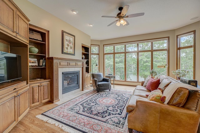 1994 80th St, Somerset, WI 54025 - living area featuring plenty of natural light, a fireplace, ceiling fan, and light wood finished floors