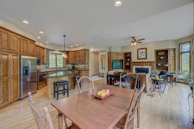 1994 80th St, Somerset, WI 54025 - dining room with light wood-type flooring, recessed lighting, plenty of natural light, ceiling fan, and a fireplace