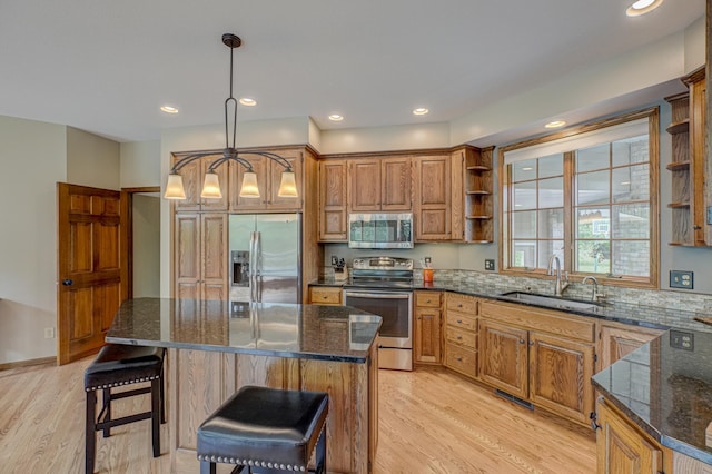 1994 80th St, Somerset, WI 54025 - kitchen featuring appliances with stainless steel finishes, a sink, open shelves, light wood-type flooring, and recessed lighting
