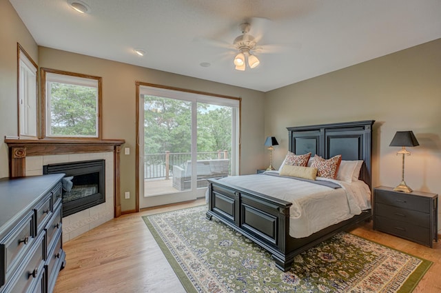 1994 80th St, Somerset, WI 54025 - bedroom with access to exterior, a fireplace, light wood-type flooring, and ceiling fan