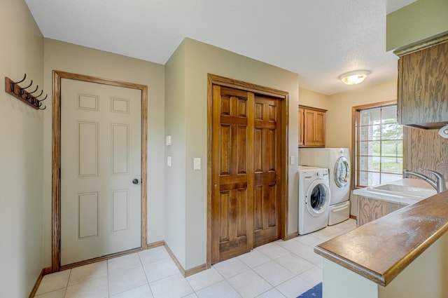 1994 80th St, Somerset, WI 54025 - washroom featuring cabinet space, washer and dryer, baseboards, and light tile patterned floors