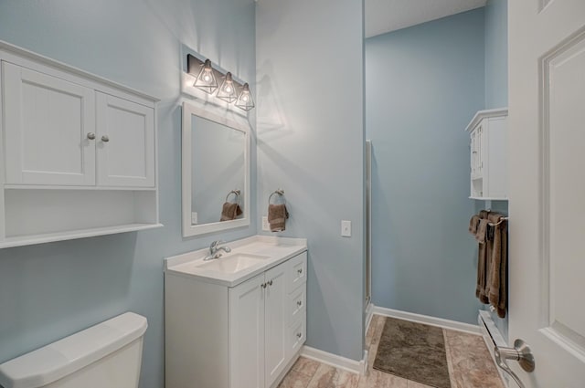 1994 80th St, Somerset, WI 54025 - full bathroom featuring toilet, vanity, a shower stall, stone finish flooring, and baseboards