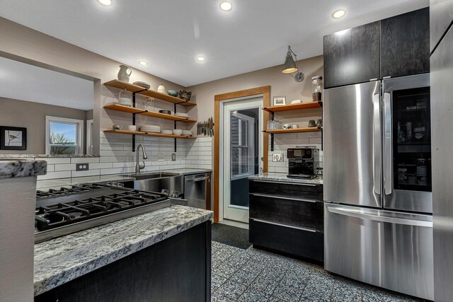 30667 Melanie Way, Collegeville Twp, MN 56374 - kitchen featuring open shelves, stainless steel appliances, a sink, light stone counters, and dark cabinets