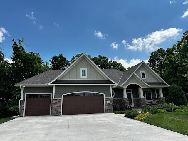 2008 Little Creek Cir, Rockford, MN 55373 - craftsman-style house with stone siding, a garage, board and batten siding, and roof with shingles