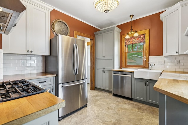 228 Sidney St W, Saint Paul, MN 55107 - kitchen featuring stainless steel appliances, tasteful backsplash, gray cabinetry, decorative light fixtures, and ornamental molding