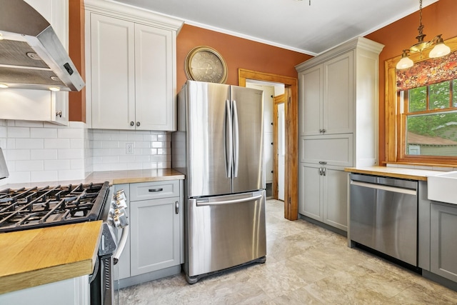 228 Sidney St W, Saint Paul, MN 55107 - kitchen featuring appliances with stainless steel finishes, wall chimney range hood, wood counters, tasteful backsplash, and hanging light fixtures