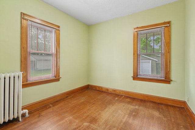 228 Sidney St W, Saint Paul, MN 55107 - unfurnished room with radiator and hardwood / wood-style flooring