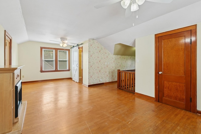 228 Sidney St W, Saint Paul, MN 55107 - unfurnished living room with ceiling fan, light wood-style floors, lofted ceiling, and a high end fireplace