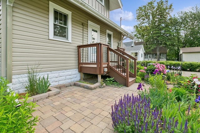 228 Sidney St W, Saint Paul, MN 55107 - view of exterior entry with board and batten siding and a patio
