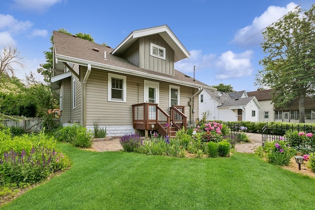 228 Sidney St W, Saint Paul, MN 55107 - rear view of property with board and batten siding and a shingled roof