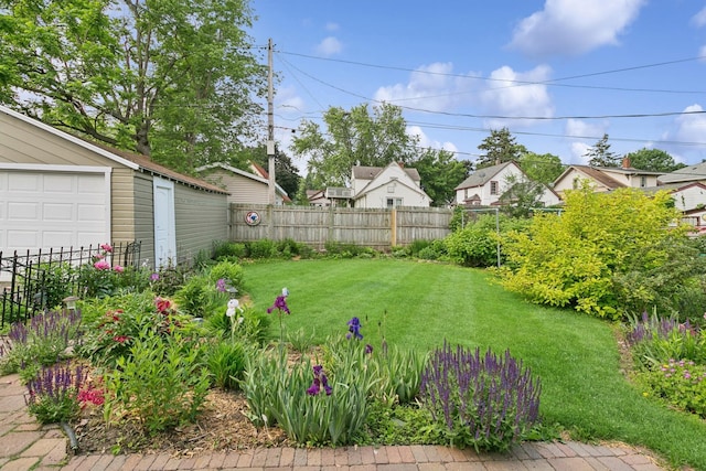 228 Sidney St W, Saint Paul, MN 55107 - fenced backyard featuring a garage, a residential view, and an outdoor structure