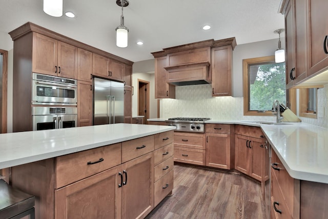 6033 Sargent Ct N, Lino Lakes, MN 55110 - kitchen featuring stainless steel appliances, a sink, light countertops, pendant lighting, and recessed lighting