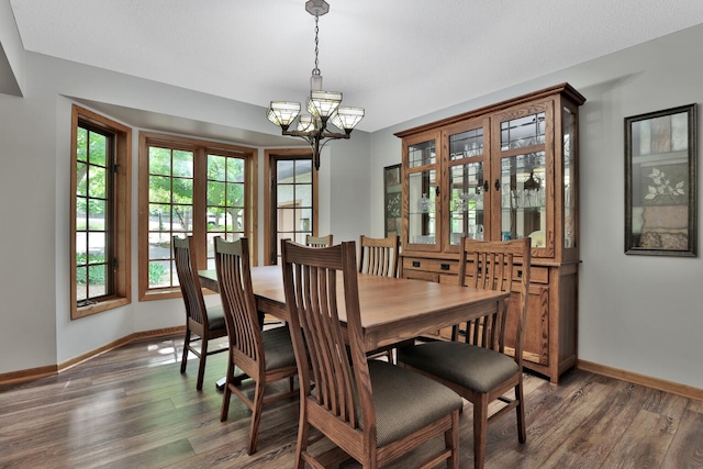 6033 Sargent Ct N, Lino Lakes, MN 55110 - dining space featuring a chandelier, baseboards, and dark wood-style floors