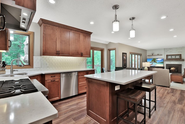 6033 Sargent Ct N, Lino Lakes, MN 55110 - kitchen with stainless steel dishwasher, light wood-style flooring, light countertops, tasteful backsplash, and recessed lighting