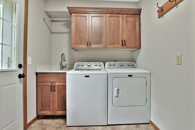 6033 Sargent Ct N, Lino Lakes, MN 55110 - laundry area with cabinet space, washer and dryer, baseboards, and light tile patterned floors