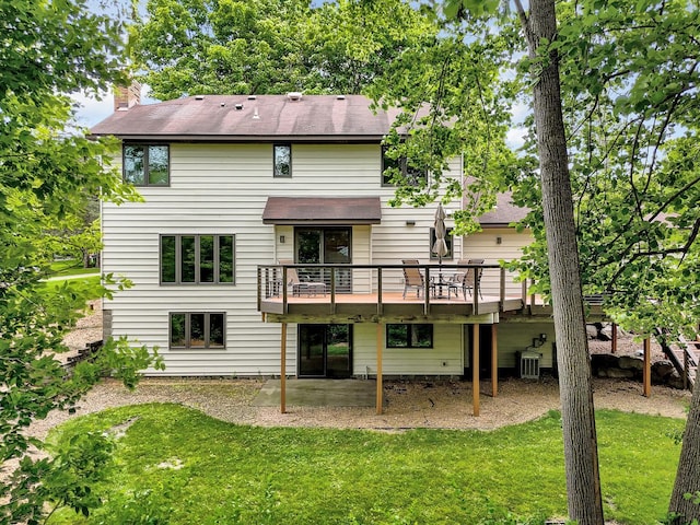6033 Sargent Ct N, Lino Lakes, MN 55110 - back of house featuring a lawn, a deck, cooling unit, a chimney, and a shingled roof