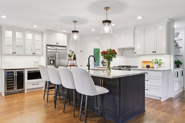 3930 Cottage Ln, Minnetonka, MN 55305 - kitchen featuring beverage cooler, white cabinetry, decorative backsplash, a kitchen breakfast bar, and recessed lighting