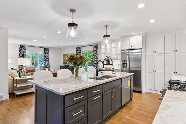 3930 Cottage Ln, Minnetonka, MN 55305 - kitchen featuring stainless steel appliances, white cabinets, healthy amount of natural light, decorative light fixtures, and recessed lighting