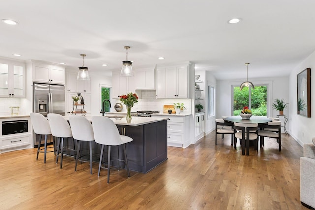 3930 Cottage Ln, Minnetonka, MN 55305 - kitchen featuring decorative backsplash, white cabinets, light countertops, and recessed lighting