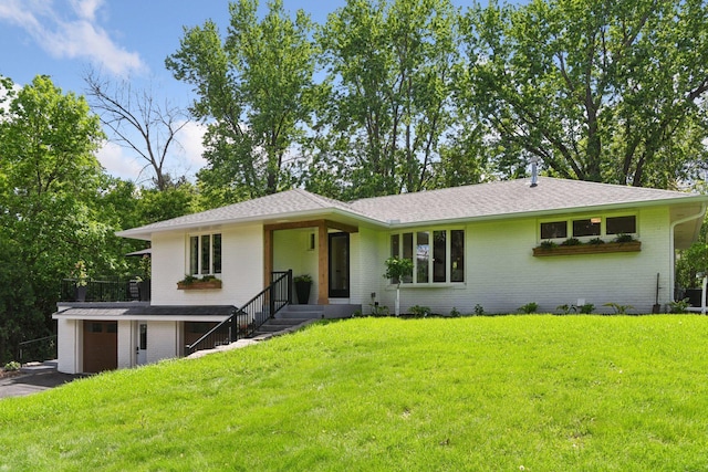 3930 Cottage Ln, Minnetonka, MN 55305 - view of front of property featuring brick siding, a front yard, roof with shingles, and asphalt driveway