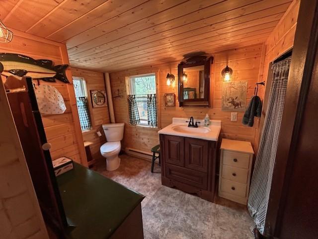 N11464 Fremont Ave, Chicog Twp, WI 54888 - bathroom with wooden ceiling, vanity, wood walls, toilet, and baseboard heating