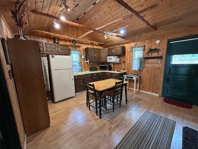 N11464 Fremont Ave, Chicog Twp, WI 54888 - kitchen with freestanding refrigerator, wooden ceiling, light wood-style flooring, dark brown cabinetry, and wood walls
