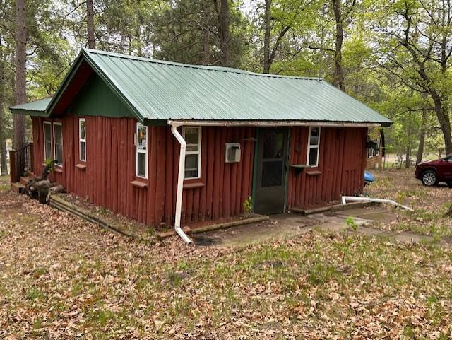 N11464 Fremont Ave, Chicog Twp, WI 54888 - view of outbuilding with view of scattered trees