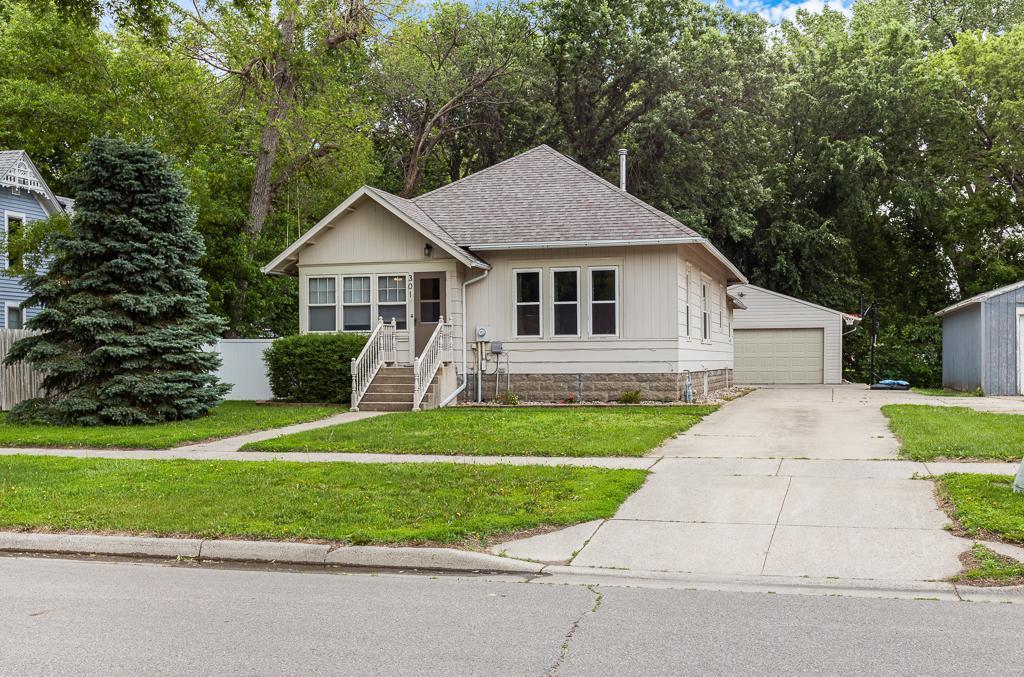301 4th St, Marshall, MN 56258 - bungalow-style house featuring an outbuilding, a garage, and roof with shingles