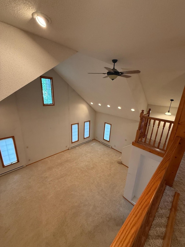 306 1st St, Belview, MN 56214 - unfurnished living room featuring ceiling fan, carpet floors, lofted ceiling, recessed lighting, and a baseboard heating unit