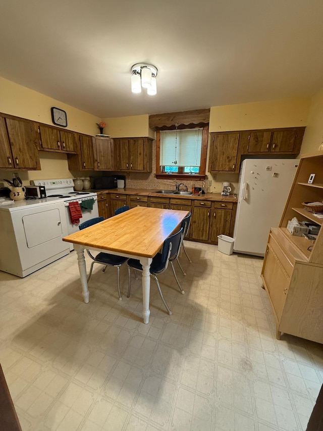 306 1st St, Belview, MN 56214 - kitchen with white appliances, washer / clothes dryer, light floors, and light countertops