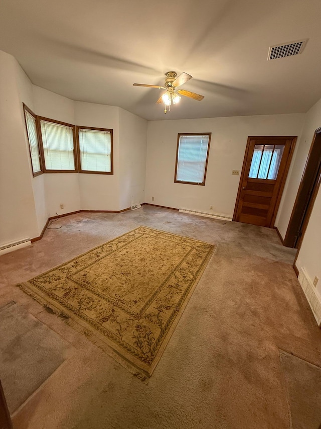 306 1st St, Belview, MN 56214 - foyer with light carpet, ceiling fan, and baseboard heating