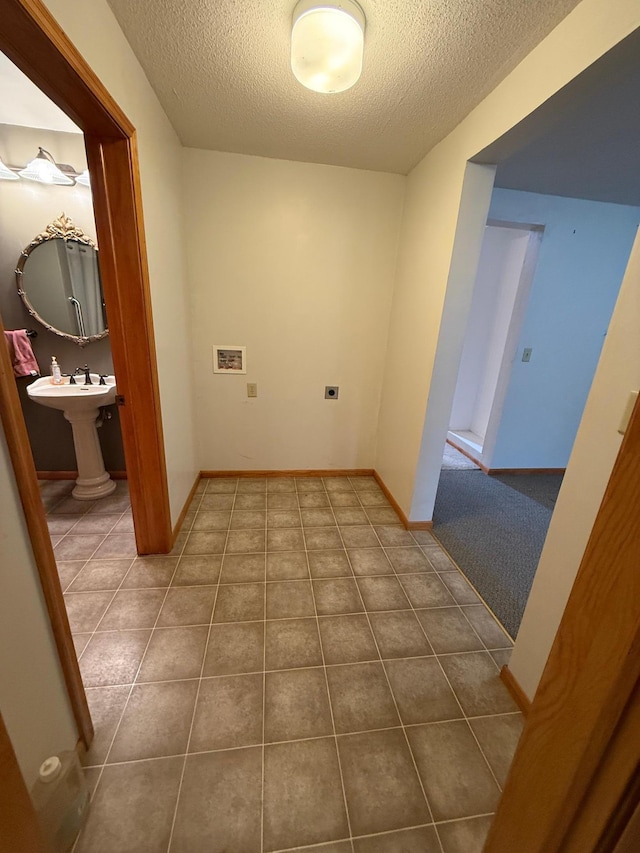 306 1st St, Belview, MN 56214 - laundry area featuring a textured ceiling and tile patterned floors