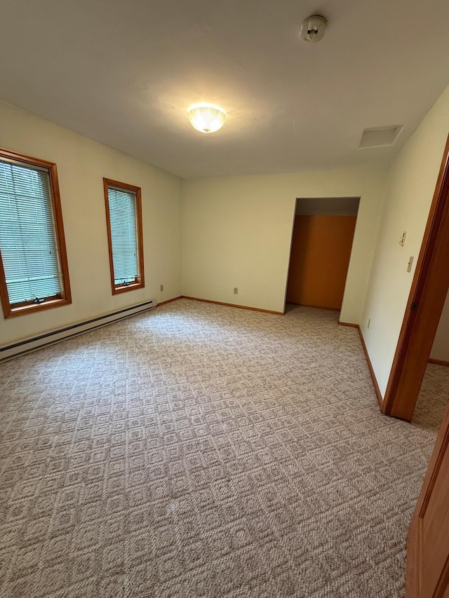 306 1st St, Belview, MN 56214 - spare room featuring a baseboard radiator, light colored carpet, and a smoke detector
