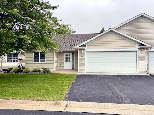 727 Cloud St NW, Bemidji, MN 56601 - single story home with a front lawn, driveway, an attached garage, and roof with shingles