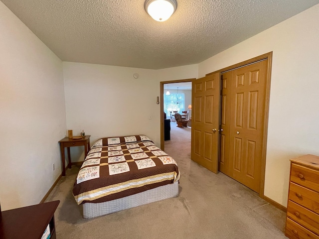 727 Cloud St NW, Bemidji, MN 56601 - bedroom featuring light carpet, a textured ceiling, and a closet