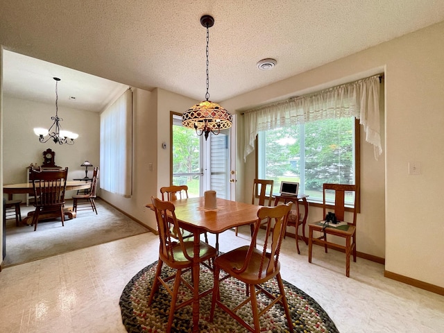 727 Cloud St NW, Bemidji, MN 56601 - dining area with a chandelier, baseboards, a textured ceiling, light floors, and light carpet