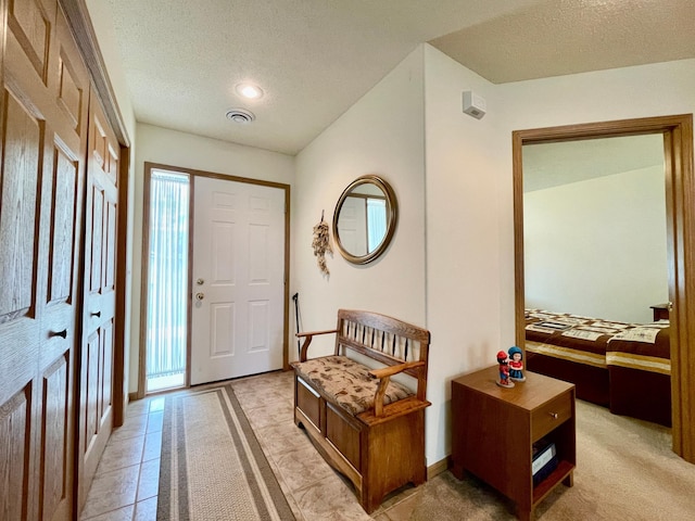 727 Cloud St NW, Bemidji, MN 56601 - entrance foyer with a textured ceiling, baseboards, and light tile patterned floors