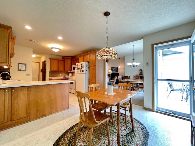 727 Cloud St NW, Bemidji, MN 56601 - dining area featuring a textured ceiling, recessed lighting, a chandelier, and light floors