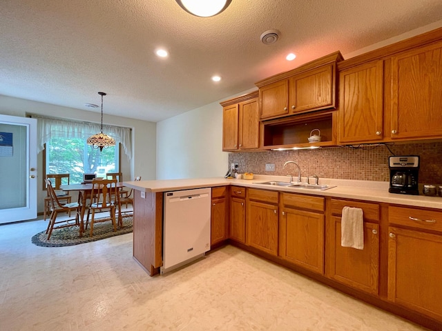 727 Cloud St NW, Bemidji, MN 56601 - kitchen with dishwasher, a sink, brown cabinetry, a peninsula, and light countertops