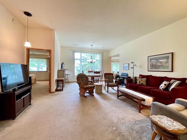 727 Cloud St NW, Bemidji, MN 56601 - living room with a chandelier, light carpet, and a textured ceiling