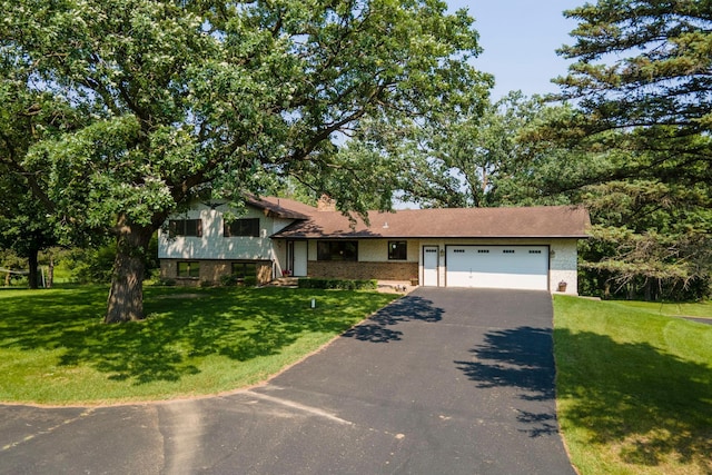 17855 Round Lake Blvd NW, Andover, MN 55304 - split level home with driveway, an attached garage, brick siding, and a front lawn