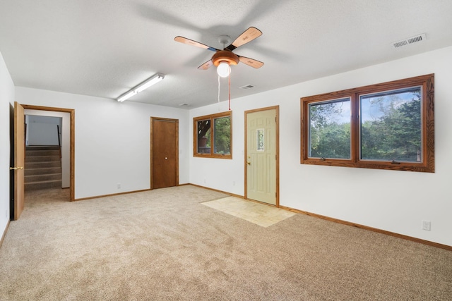 17855 Round Lake Blvd NW, Andover, MN 55304 - carpeted empty room with a ceiling fan and stairway