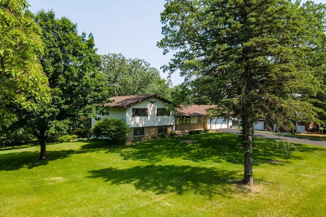 17855 Round Lake Blvd NW, Andover, MN 55304 - split level home featuring a front lawn, asphalt driveway, and an attached garage