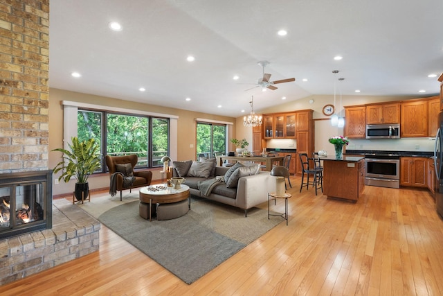 17855 Round Lake Blvd NW, Andover, MN 55304 - living area with a fireplace, light wood-style floors, lofted ceiling, a ceiling fan, and recessed lighting