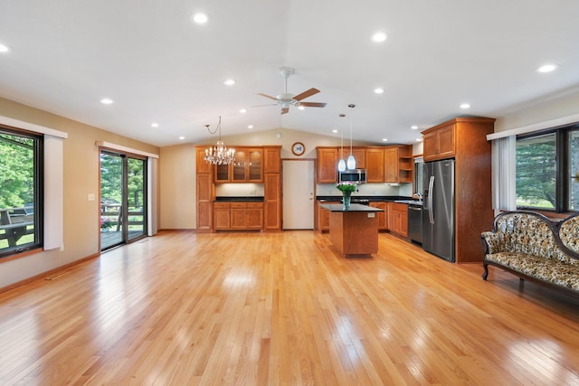 17855 Round Lake Blvd NW, Andover, MN 55304 - kitchen with appliances with stainless steel finishes, dark countertops, open shelves, brown cabinetry, and vaulted ceiling