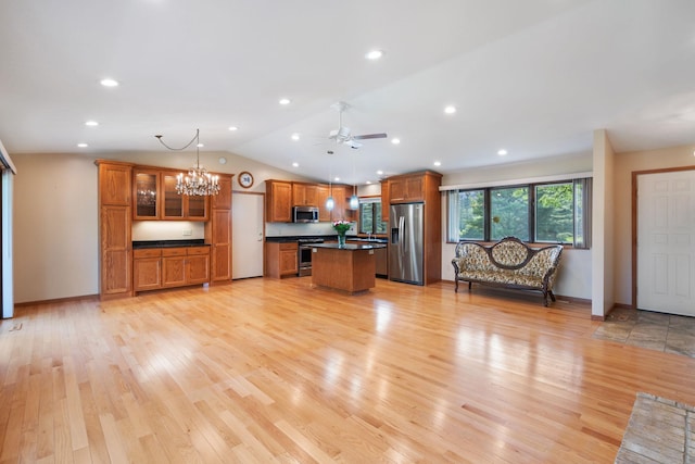 17855 Round Lake Blvd NW, Andover, MN 55304 - unfurnished living room with vaulted ceiling, ceiling fan, a chandelier, light wood-style floors, and recessed lighting