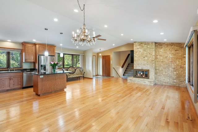 17855 Round Lake Blvd NW, Andover, MN 55304 - kitchen featuring stainless steel appliances, healthy amount of natural light, open floor plan, a kitchen island, and vaulted ceiling
