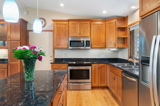 17855 Round Lake Blvd NW, Andover, MN 55304 - kitchen with stainless steel appliances, open shelves, vaulted ceiling, light wood-style flooring, and brown cabinetry